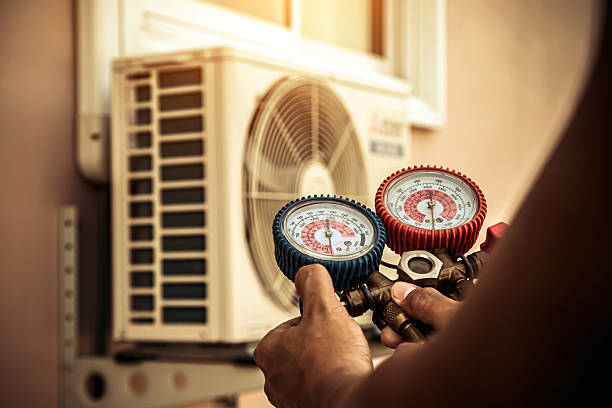 Professional Air Conditioning Service technician working in High Ridge, MO